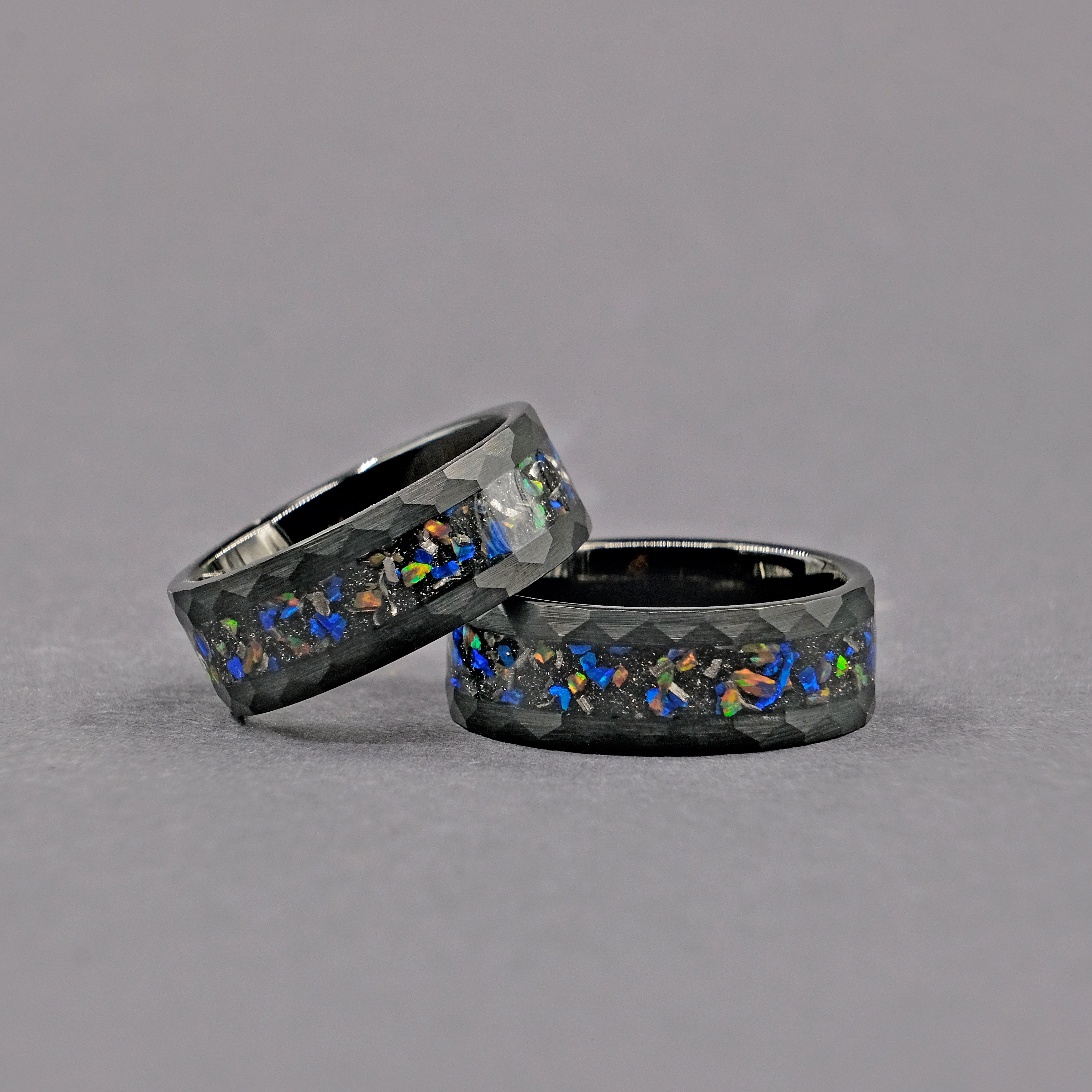 Horizontal view of the Meteorite Black Tungsten Opal Ring set, highlighting the unique combination of meteorite and opal within the durable tungsten carbide band.