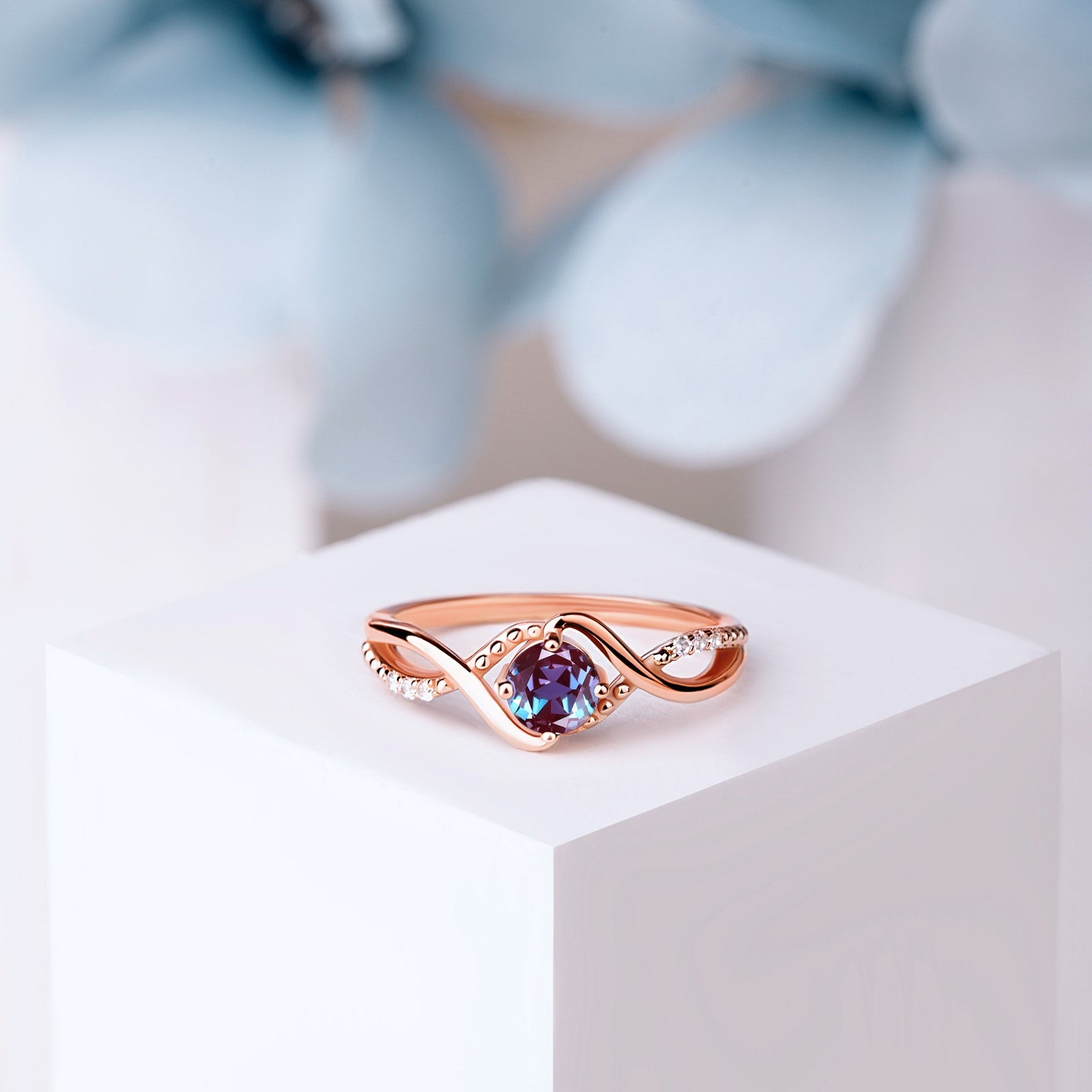 Close-up of the Rose Gold Vermeil Alexandrite Engagement Ring, featuring a 5mm oval-cut Lab Alexandrite and White Zircon accents.