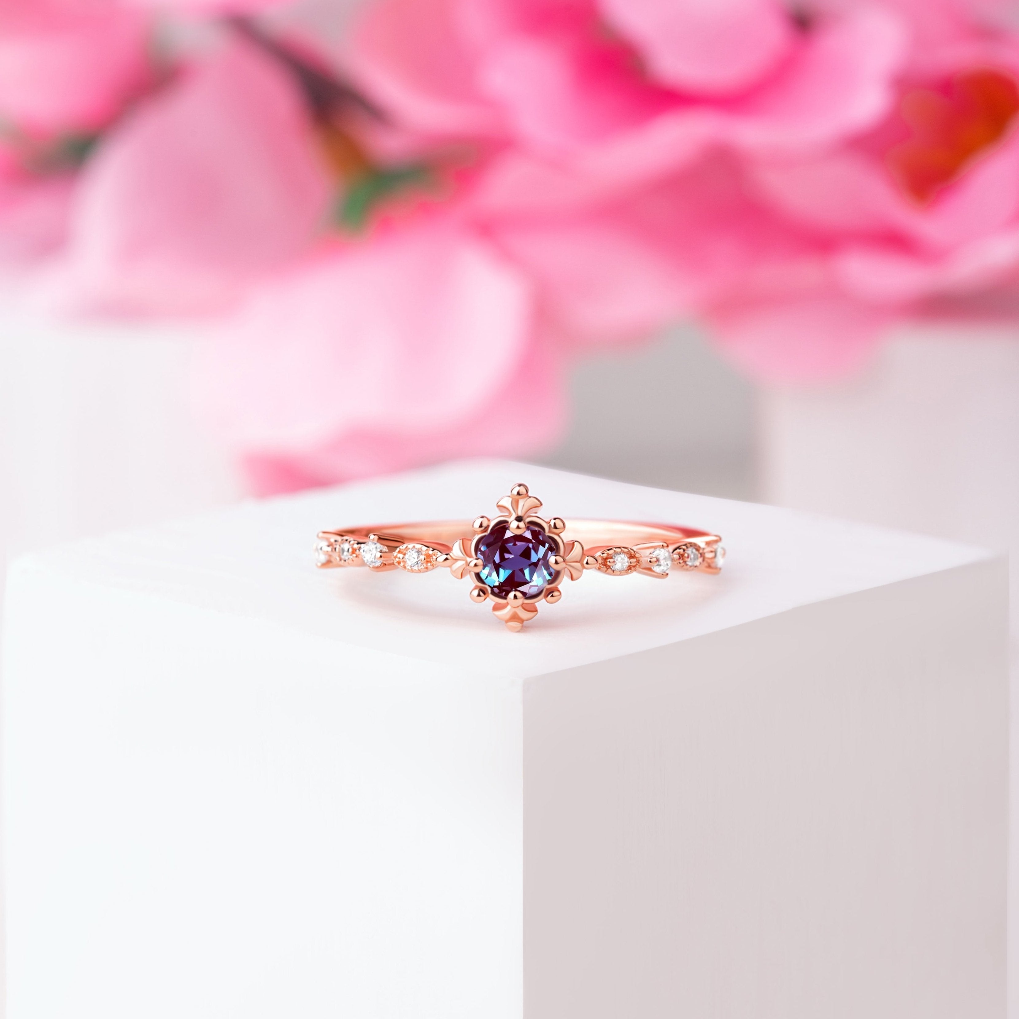 Front view of the Alexandrite Engagement Sparkling Ring in rose gold, featuring a 5mm oval-cut Alexandrite and White Zircon accents