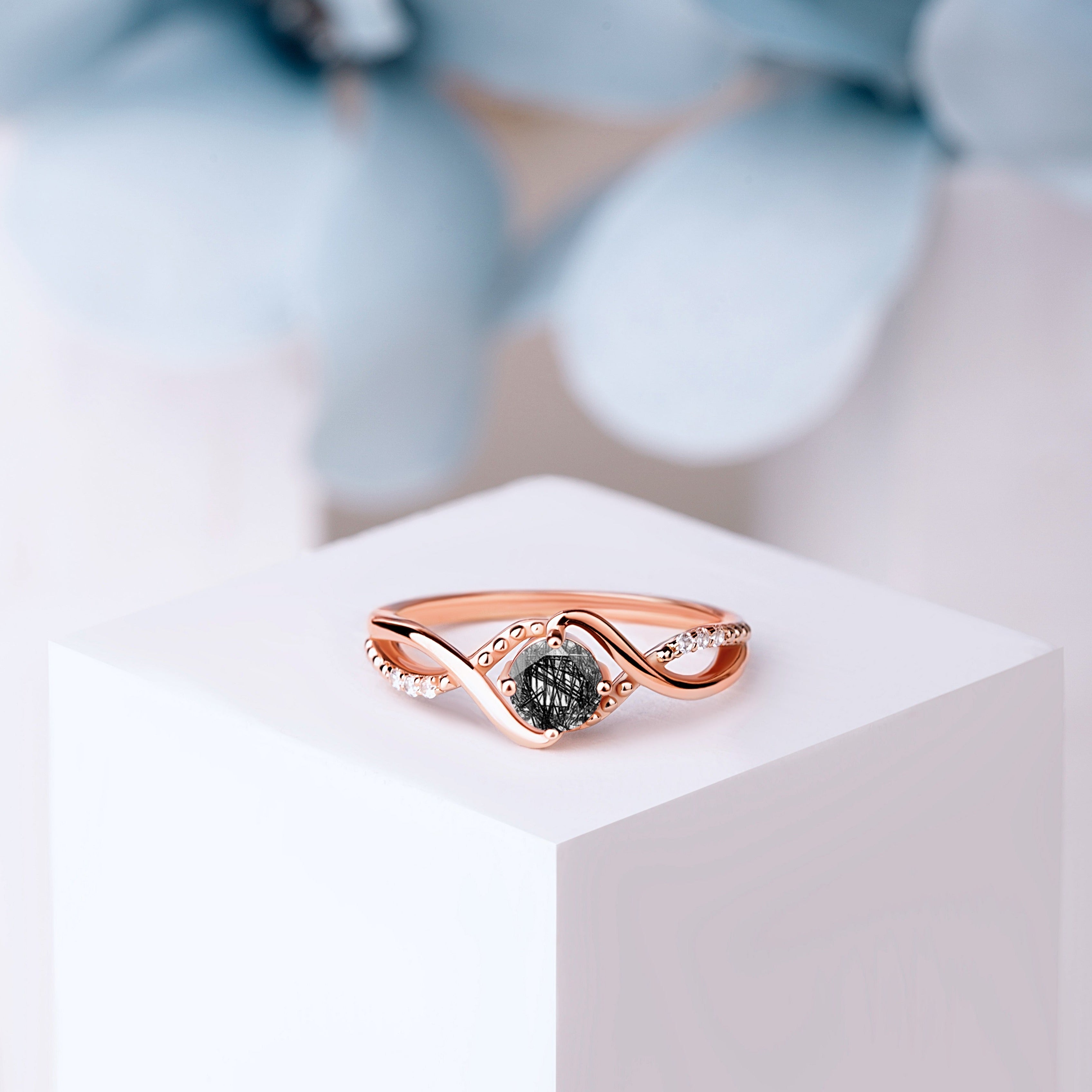 lose-up of the Black Rutilated Quartz Engagement Ring in rose gold, featuring a 5mm oval-cut Black Rutilated Quartz with unique needle-like inclusions.