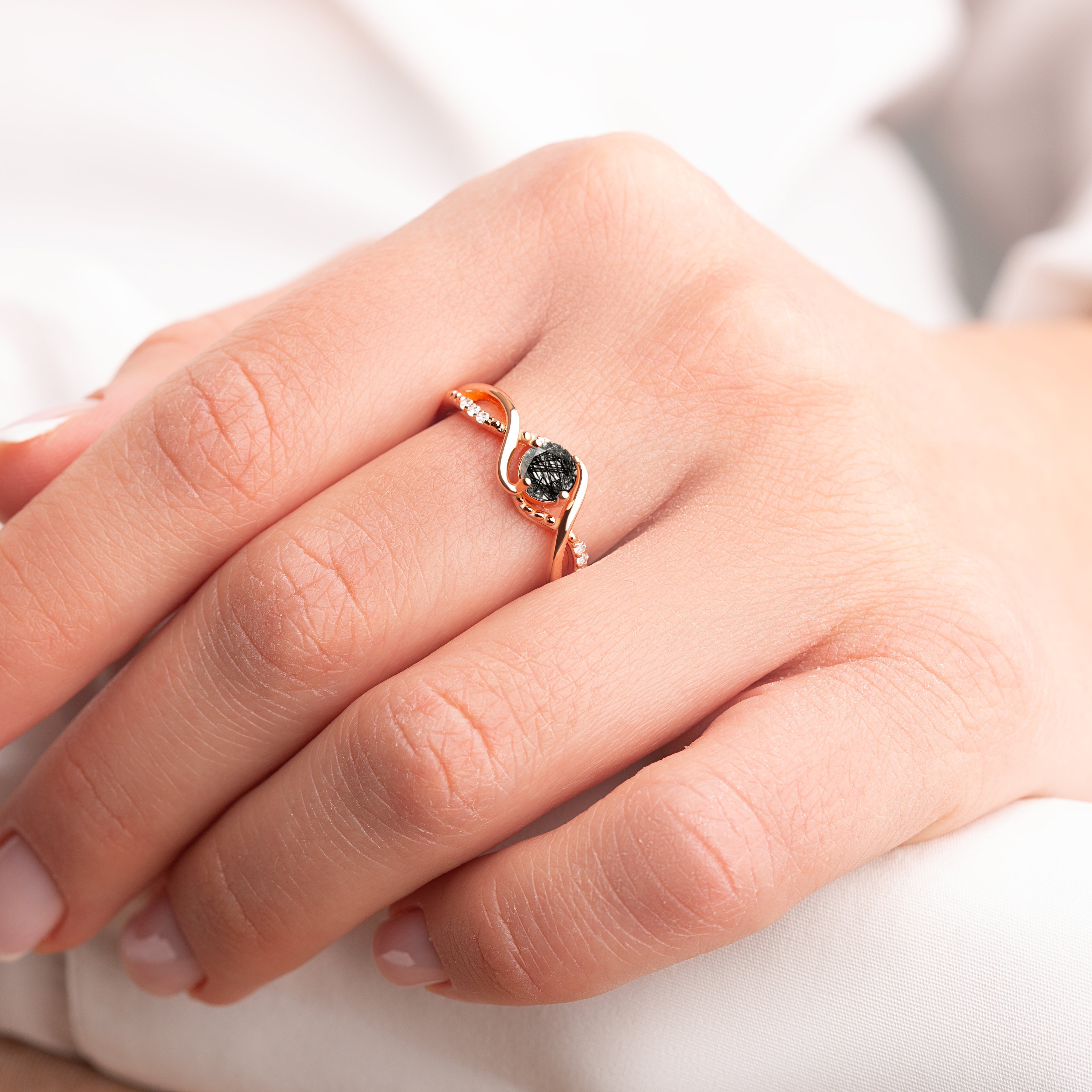 Black Rutilated Quartz Engagement Ring in rose gold, worn by a model, showcasing the sophisticated design and captivating black quartz centerpiece.