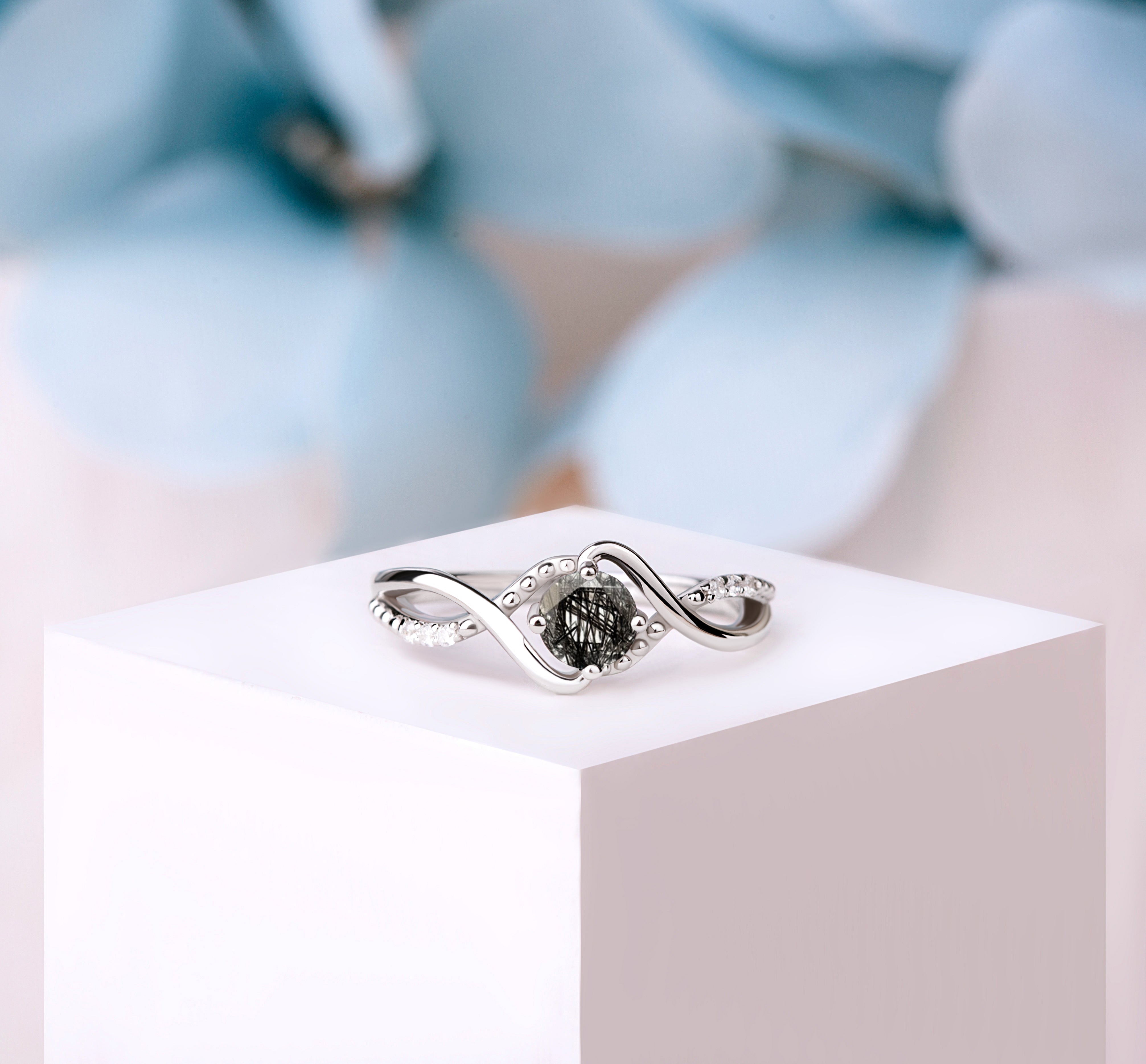 Close-up of the Black Rutilated Quartz Engagement Ring in silver, showcasing the striking black quartz and White Zircon accents.