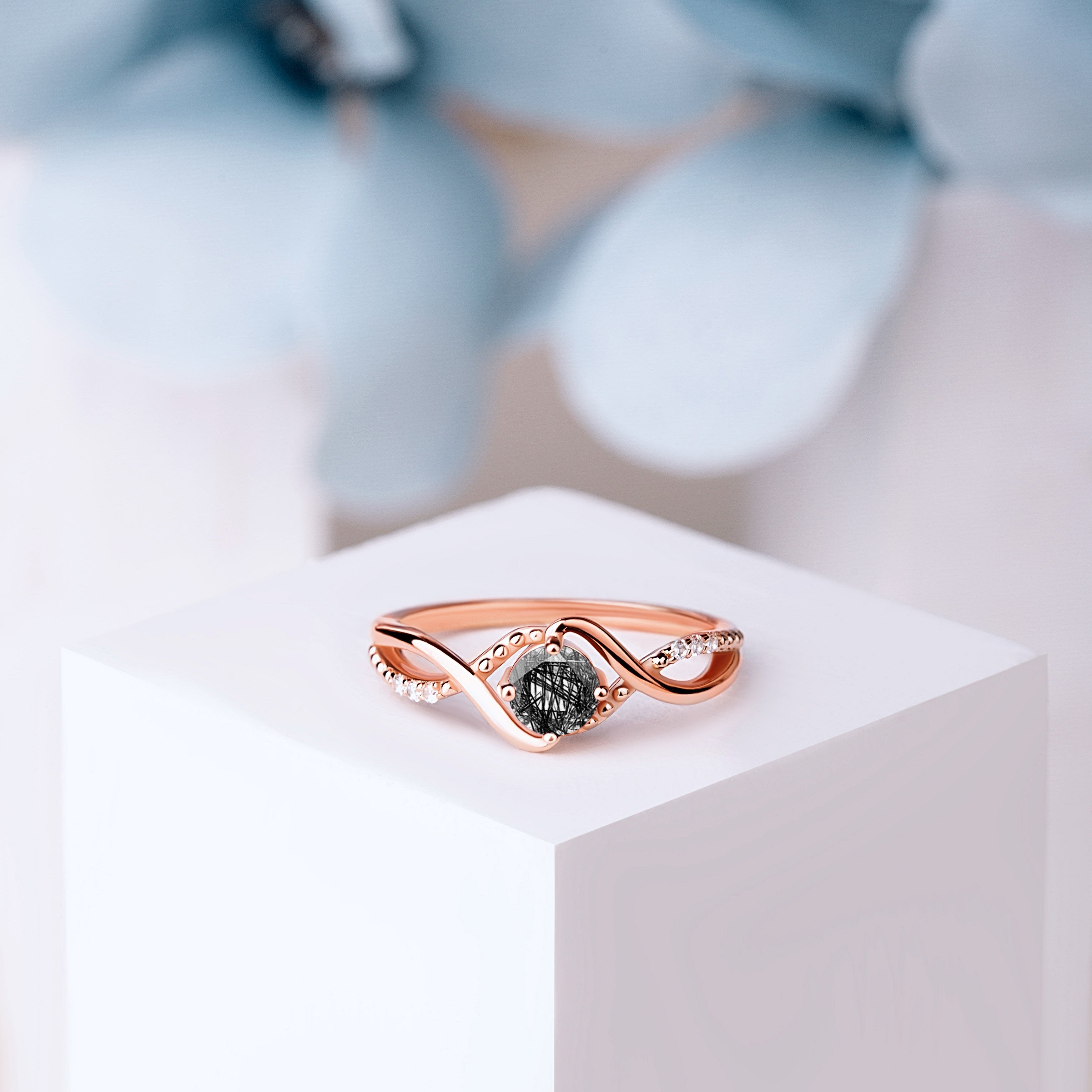 Front view of the Black Rutilated Quartz Whispers ring in rose gold, featuring a 5mm oval-cut Black Rutilated Quartz with gold-plated silver band.