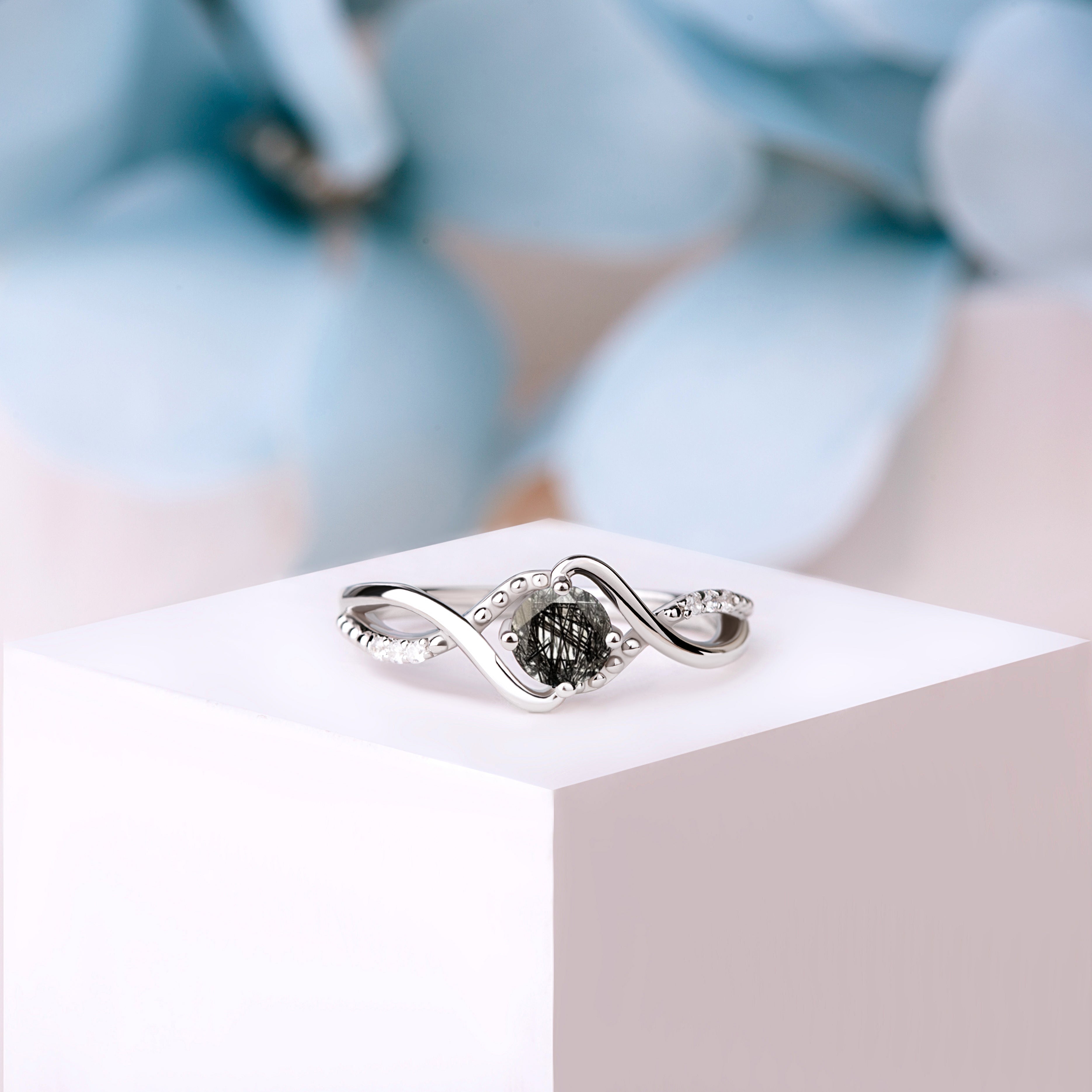 Front view of the Black Rutilated Quartz Whispers ring in silver and gold, showcasing the 5mm oval-cut Black Rutilated Quartz set in a gold-plated silver band.