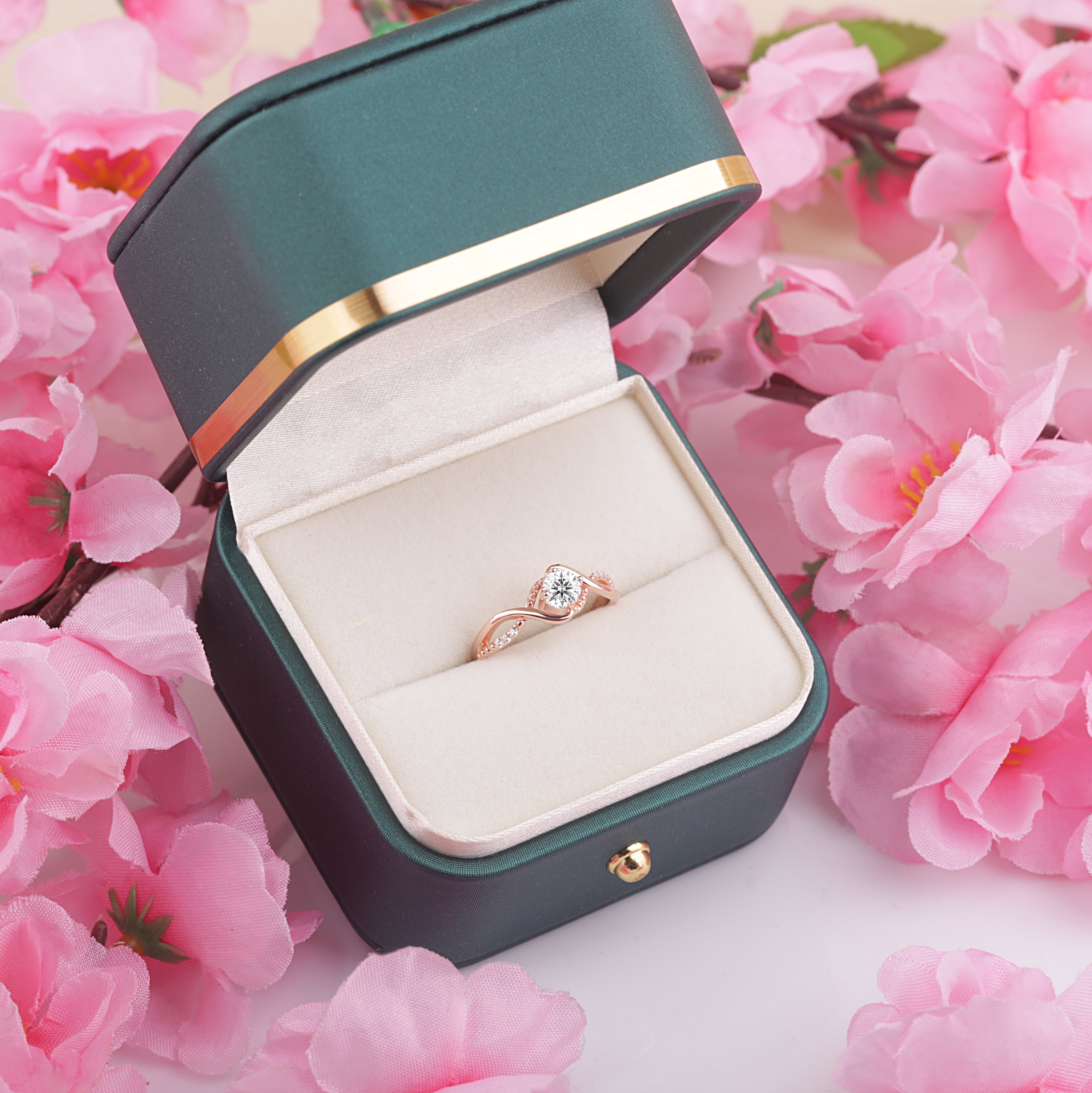 Bridal Elegance in Rose Gold ring displayed in an elegant gift box, featuring a brilliant moissanite gemstone and 24K rose gold-plated sterling silver band.