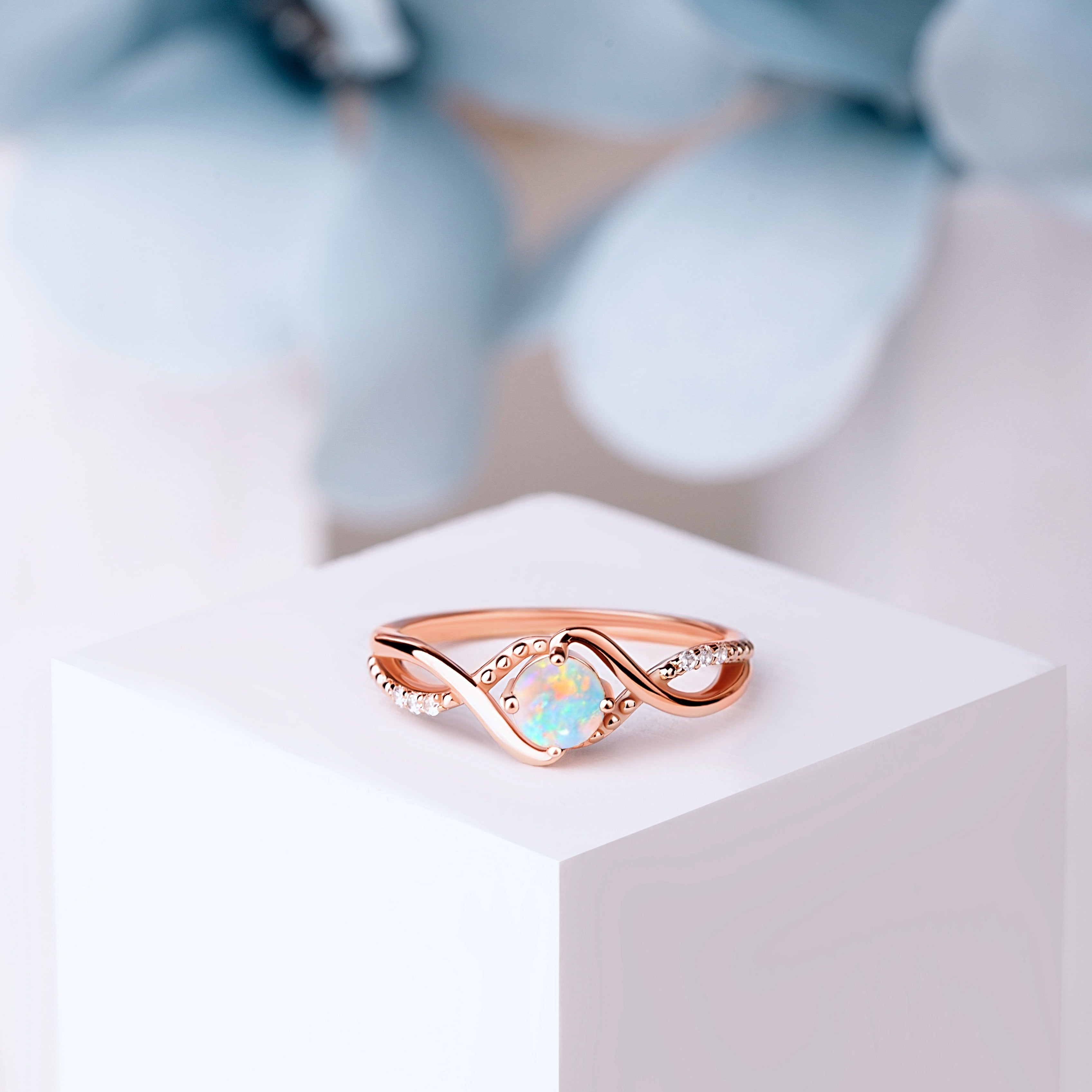 Close-up of the Bridal Opal Art Deco Wedding Ring in rose gold, showcasing the 5mm oval-cut White Opal with intricate Art Deco detailing and White Zircon accents.