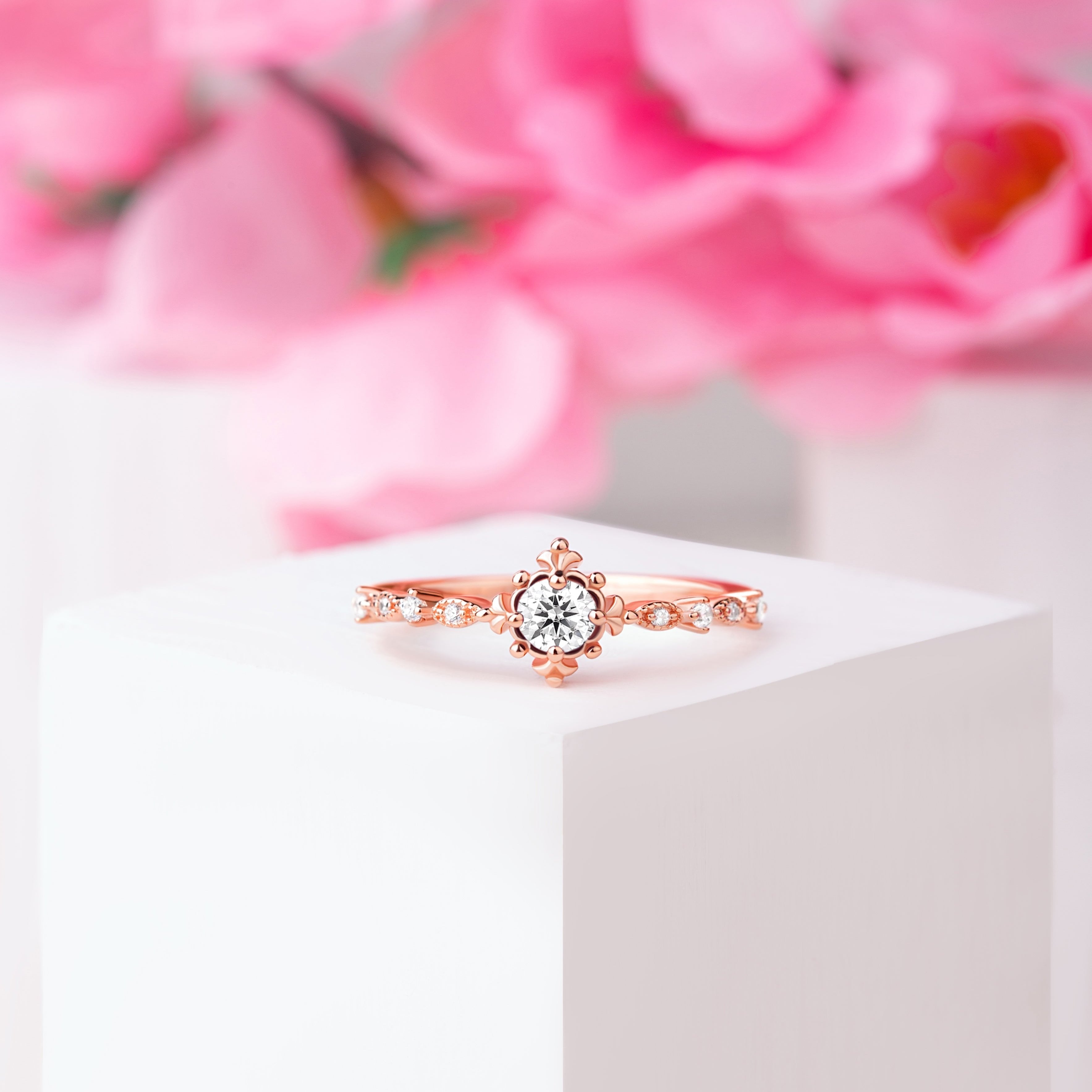 Front view of the Brisbane Unique Vintage Moissanite Engagement Ring in rose gold, showcasing the 5 mm oval-cut Moissanite and White Zircon accents.