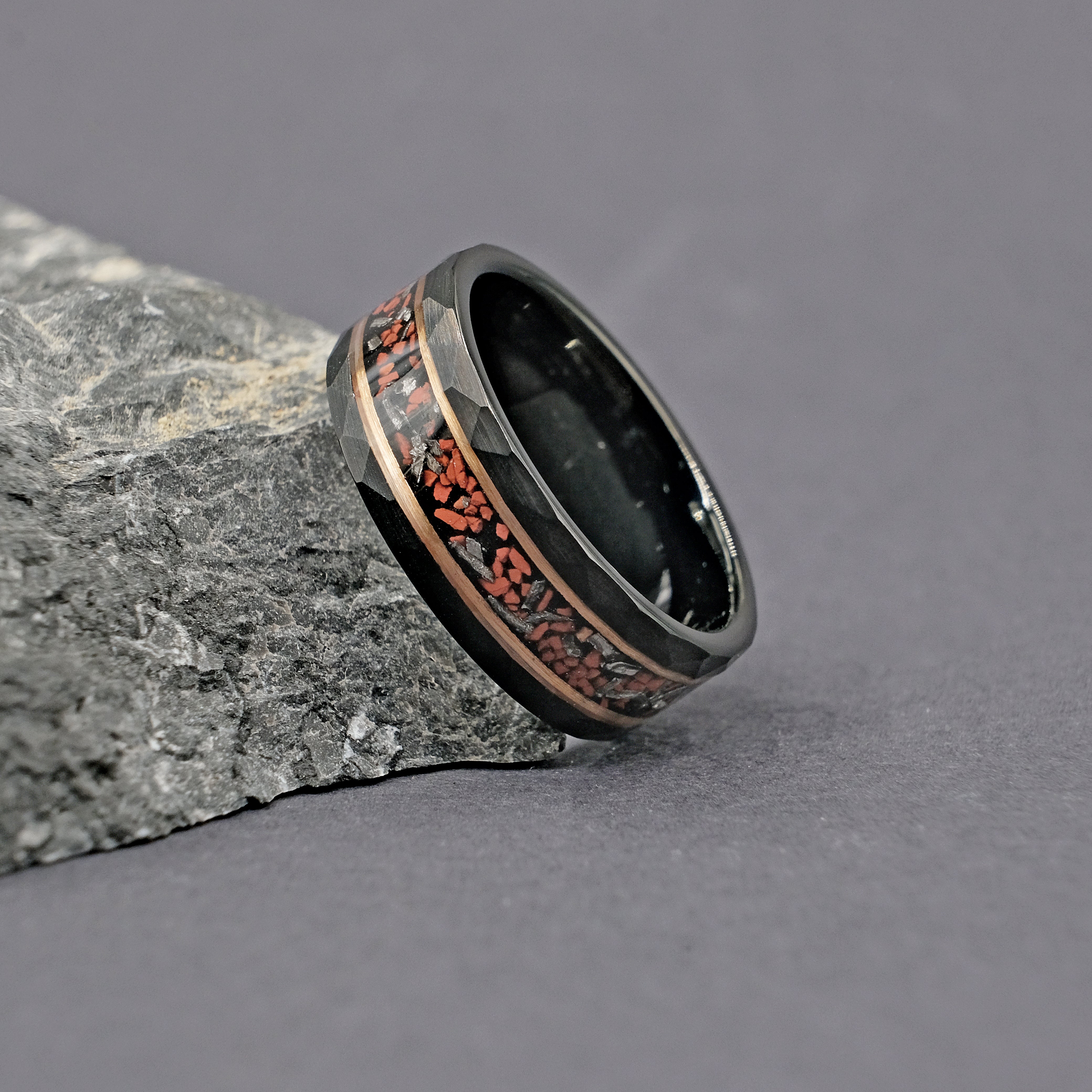 Close-up of the Exclusive Dinosaur Bone Men’s Ring, featuring a genuine dinosaur bone and Muonionalusta meteorite inlay with gold-plated tungsten band