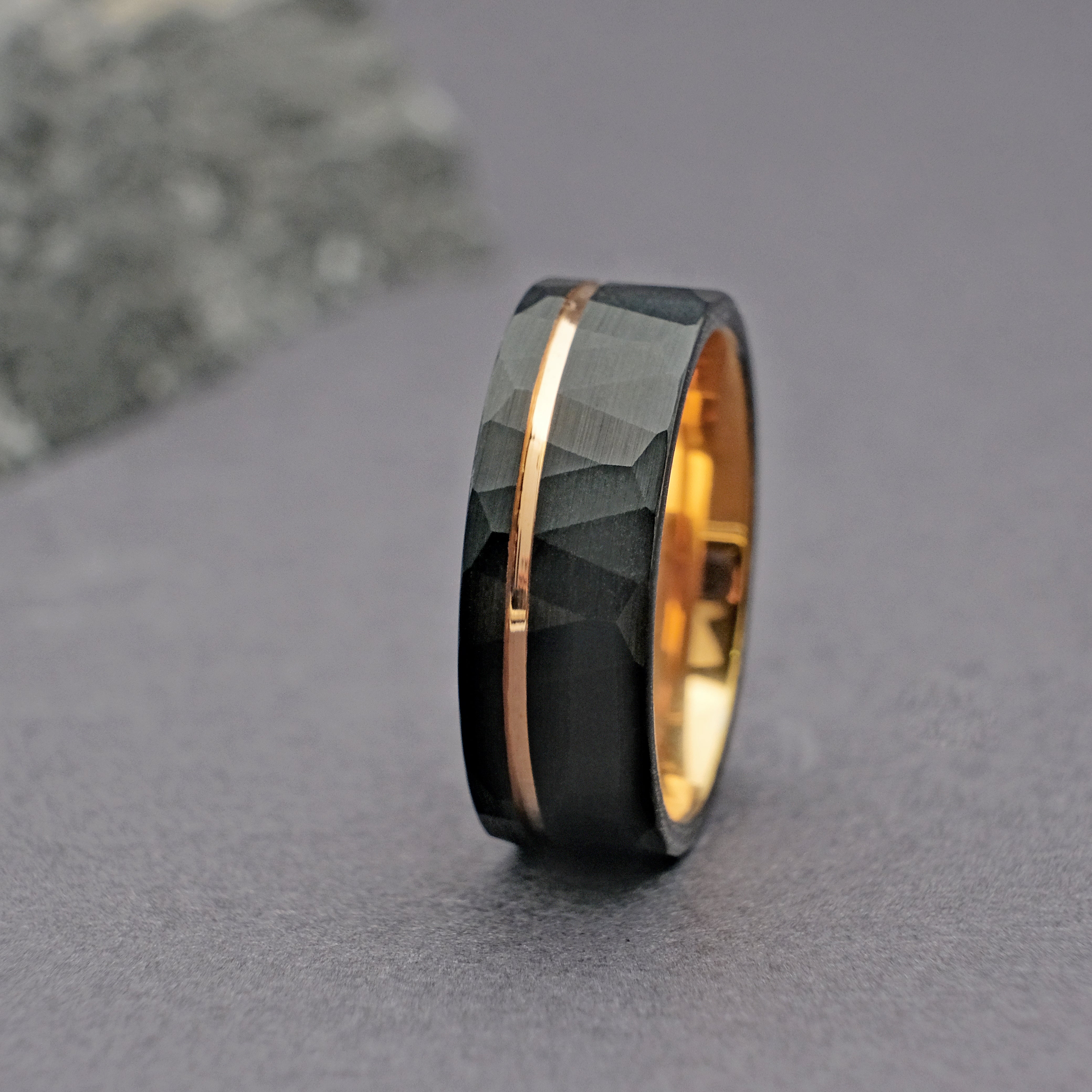 Close-up vertical shot of the Hammered Black Strip Men Ring, highlighting the hammered finish and polished gold strip accent.