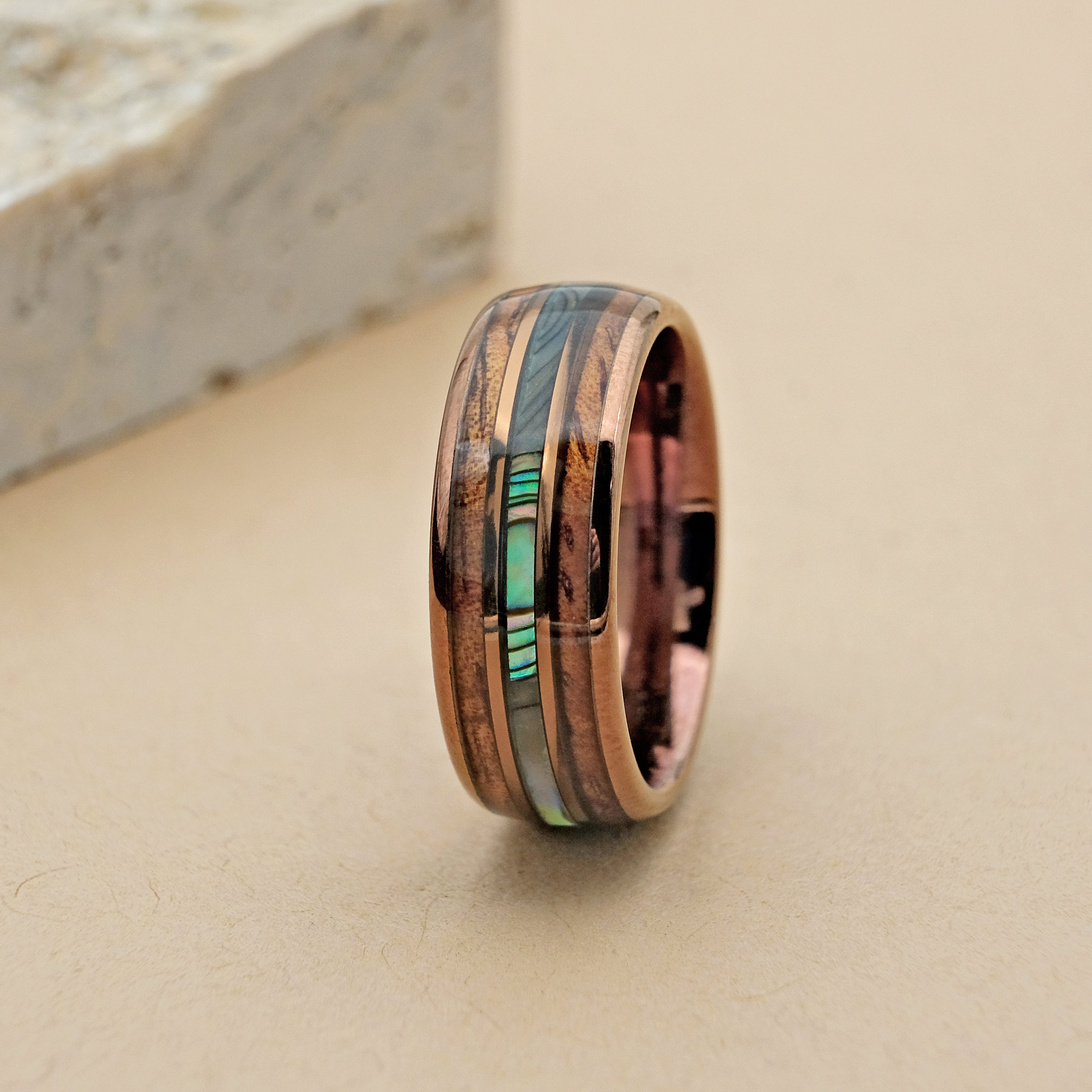 Close-up vertical shot of the Hawaiian Tungsten Ring, highlighting the intricate inlays of Koa wood and Bello Opal, and the refined 18k rose gold finish.