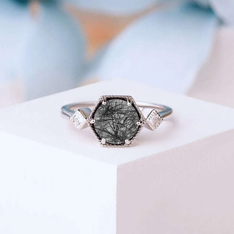 Hectagon Black Rutilated Quartz Ring in silver gold, showcasing the unique 8 x 8 mm gemstone and its bold, geometric design.