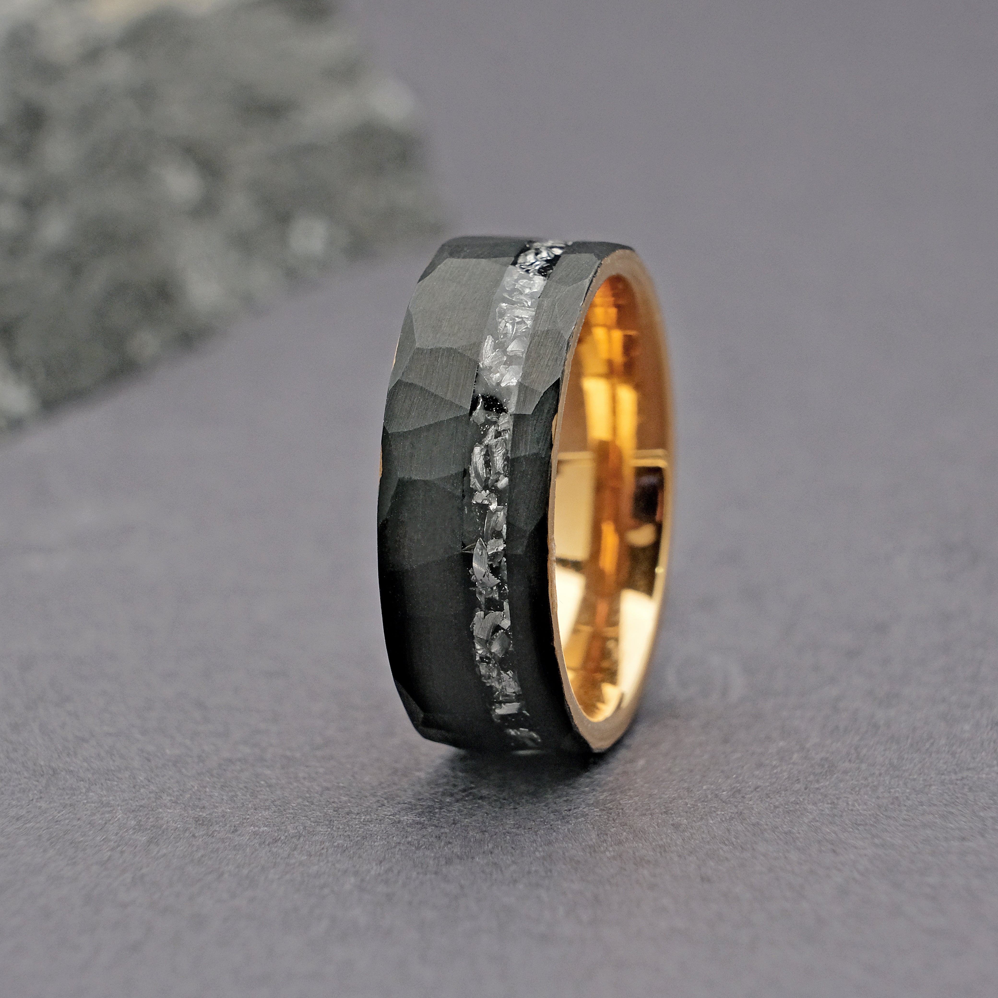 Alternative close-up vertical shot of the Meteorite Black Artisan Tungsten Ring, focusing on the Muonionalusta meteorite's distinct crystalline patterns set within a sleek tungsten carbide band.