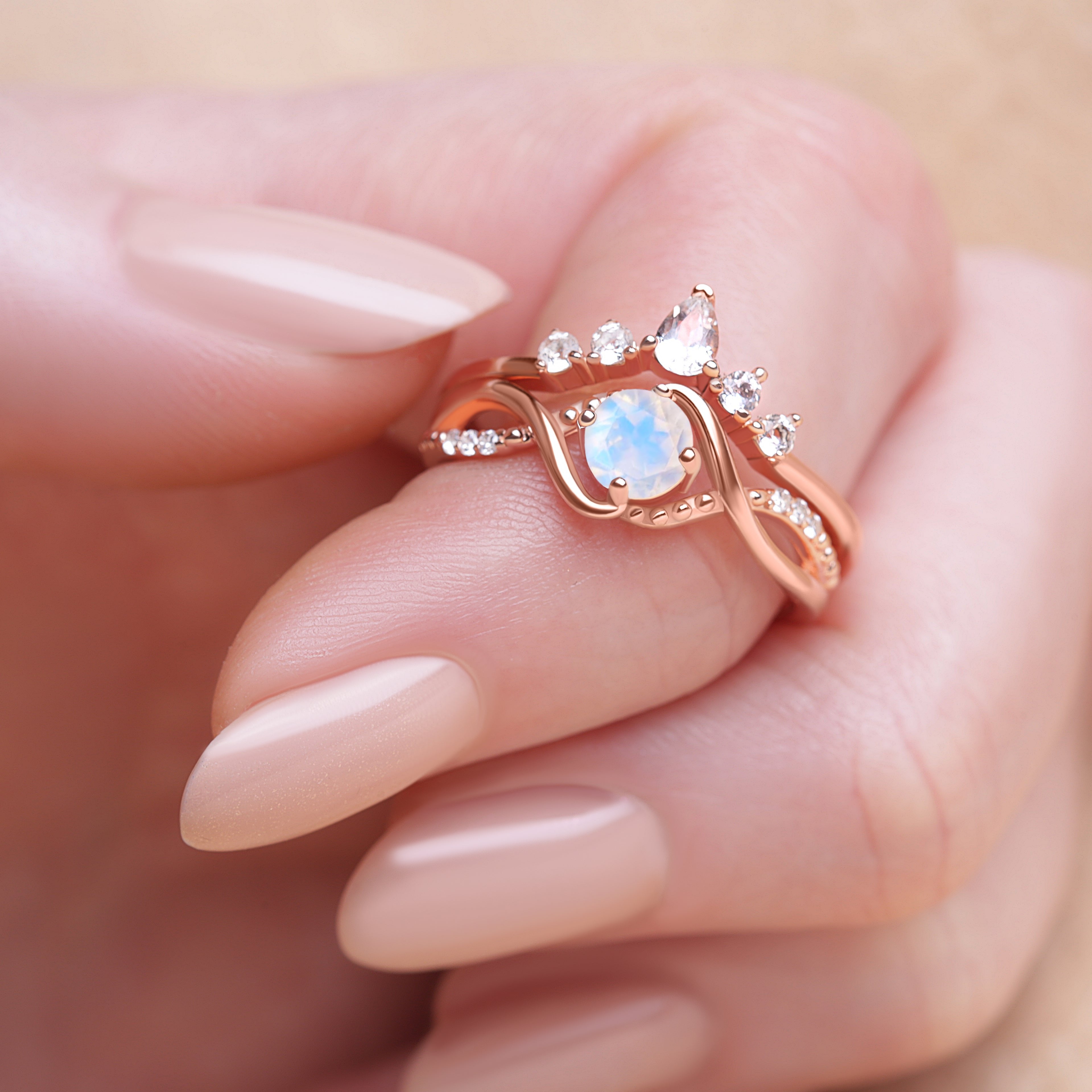 Moonstone Ring Set worn on a model's finger, showcasing the radiant moonstone and the detailed craftsmanship of the ring.