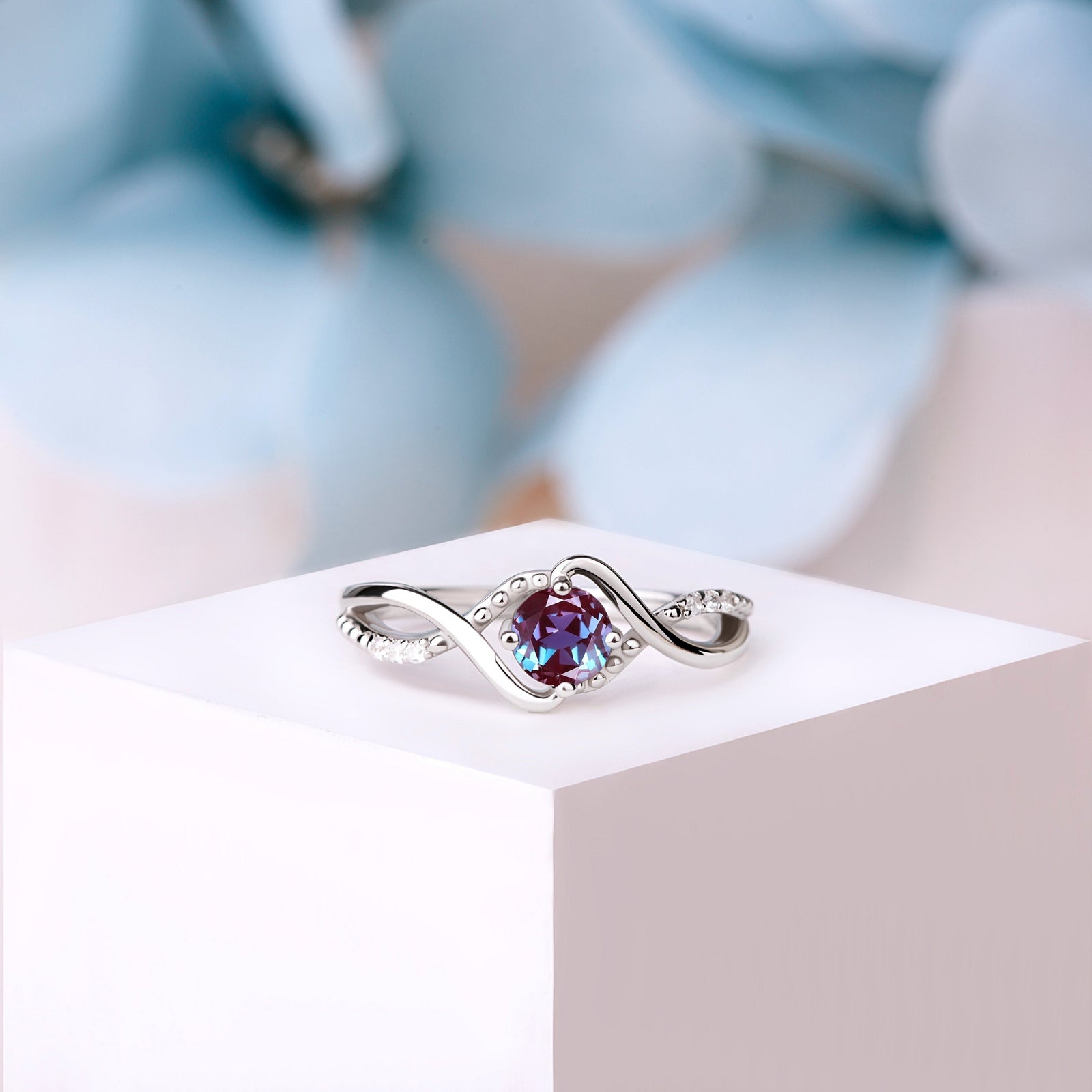 Close-up of the Silver Alexandrite Engagement Ring, showcasing the color-changing Alexandrite and sparkling White Zircon accents.