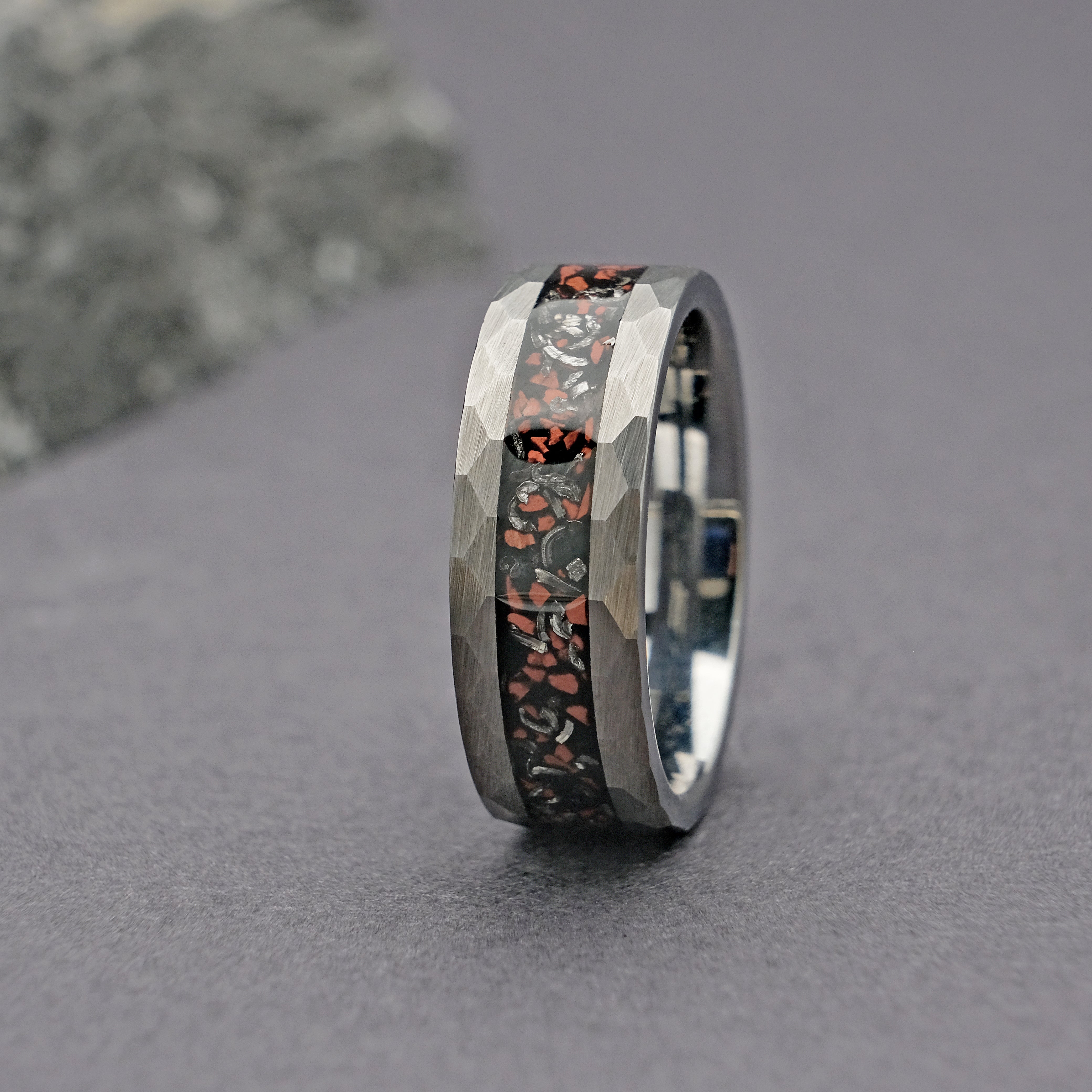 Vertical display of the Silver Dinosaur Bone Wedding Ring, highlighting the dinosaur bone and Muonionalusta meteorite inlays.