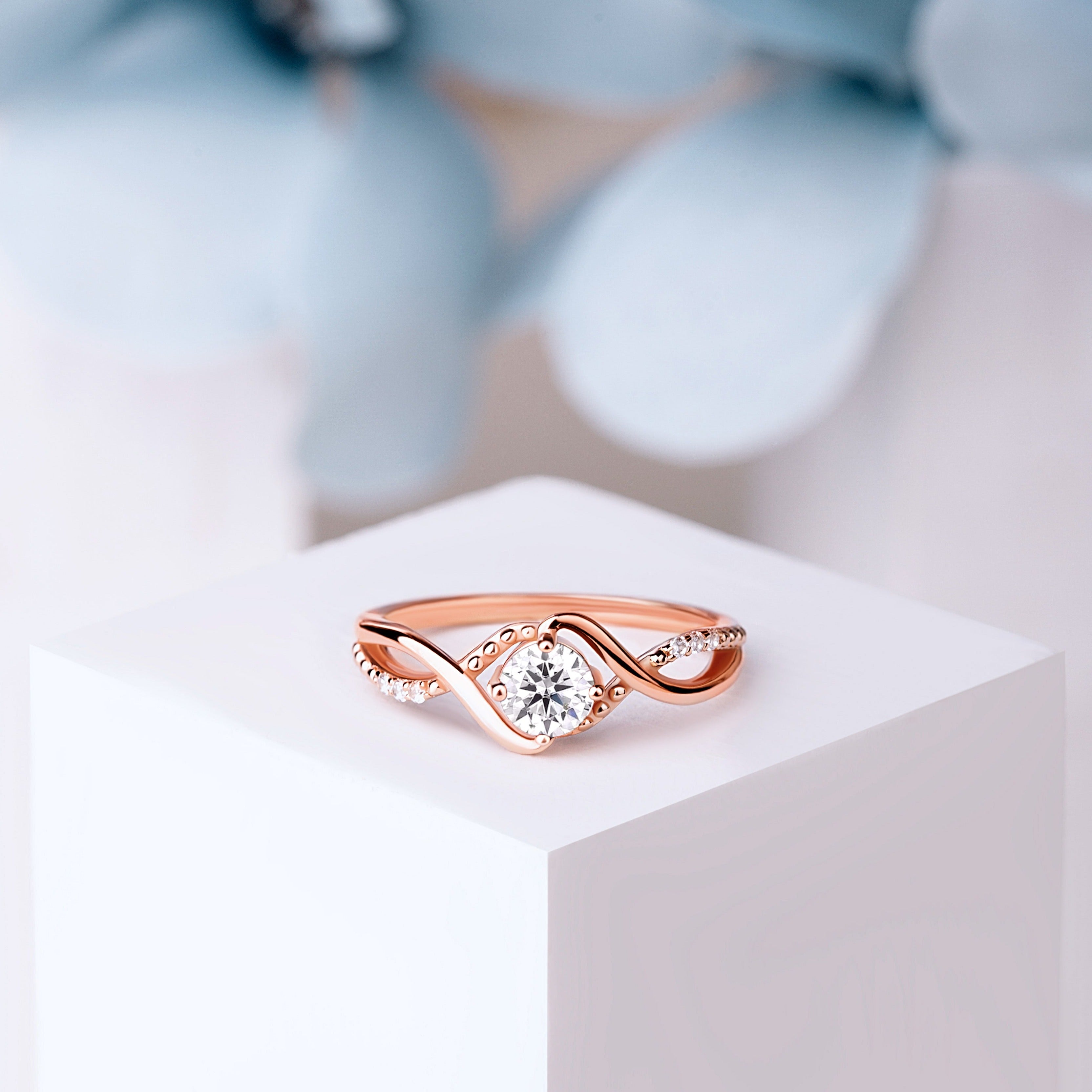 Close-up of rose gold statement ring featuring a 5mm oval-cut Moissanite, highlighting its brilliant sparkle.