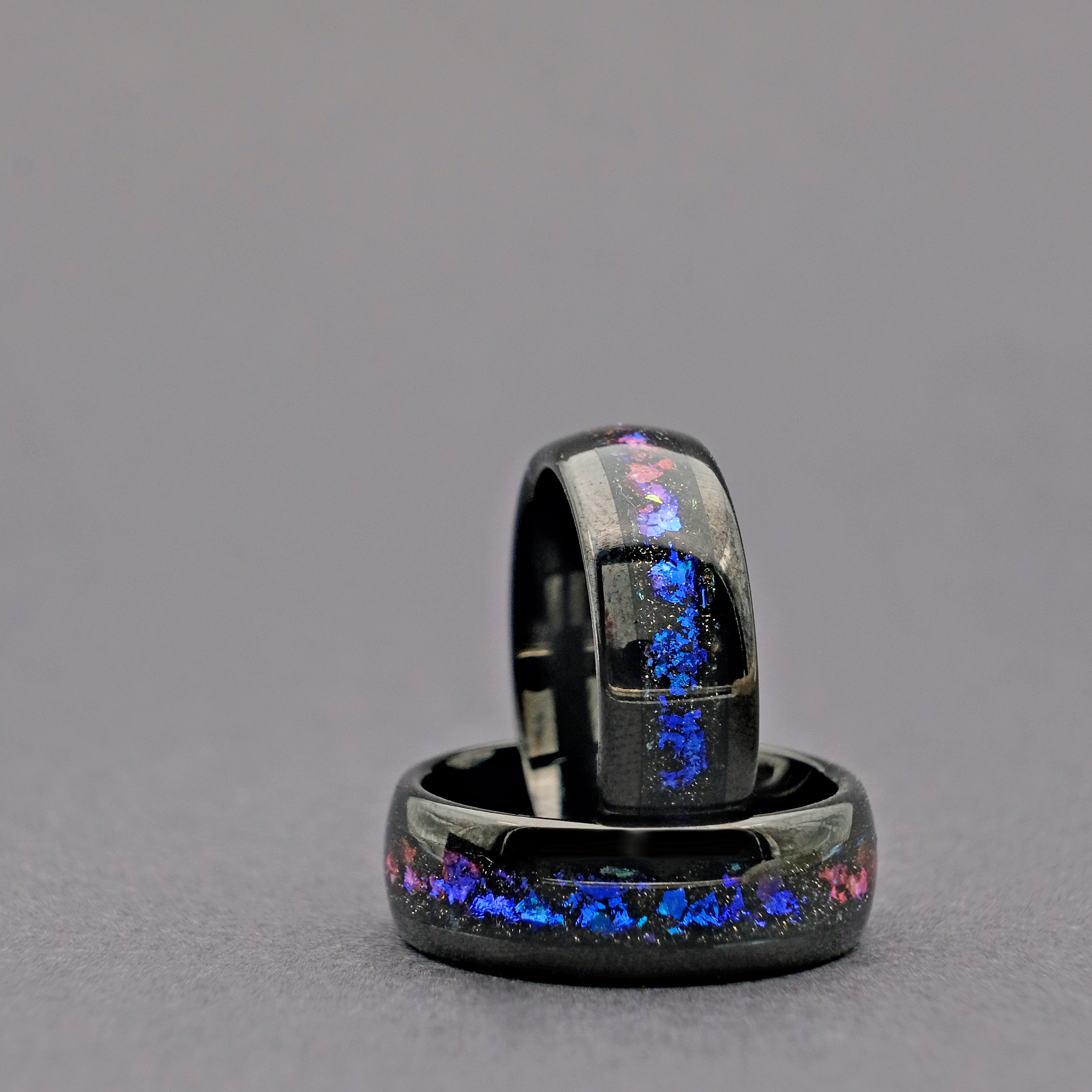 Close-up of the Unique Aqua Tungsten Wedding Ring set vertically, showcasing the intricate details of the Galaxy Opal and Tungsten band.