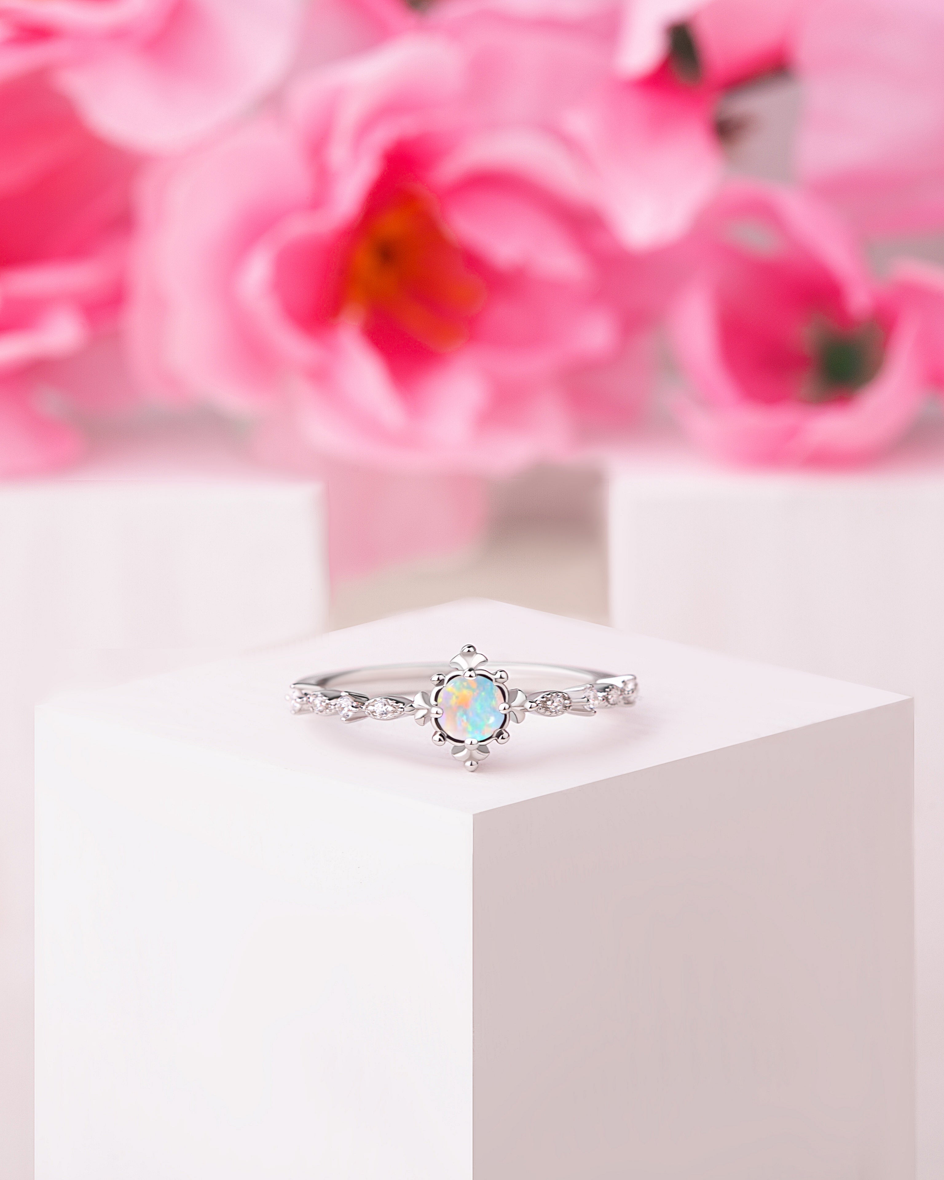 Silver vintage opal engagement ring with a 5mm oval-cut Opal centerpiece.