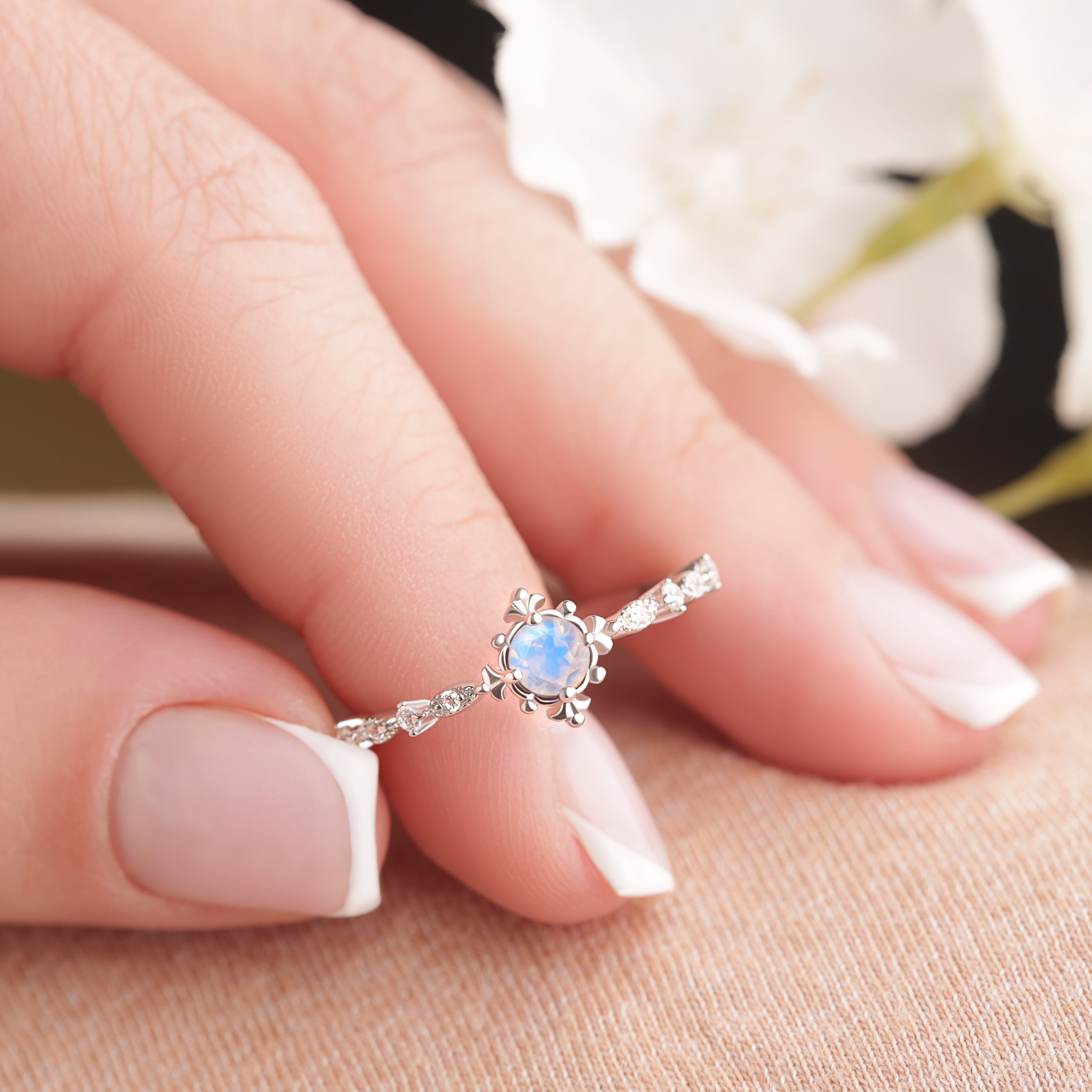 Alternate view of the Vintage Opal Whispers ring in silver and gold on model’s fingertips, showcasing the intricate craftsmanship and Opal centerpiece.